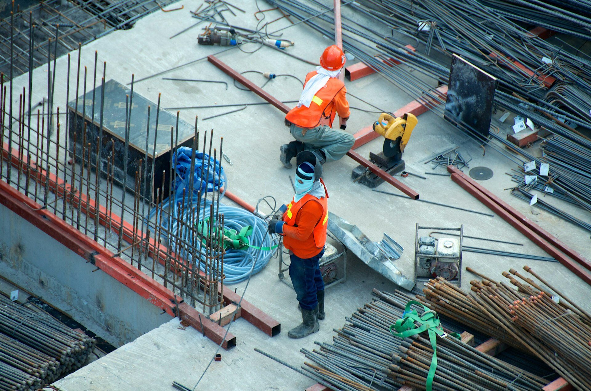 Worker wearing high-visibility vest loading items into the back of a collection truck